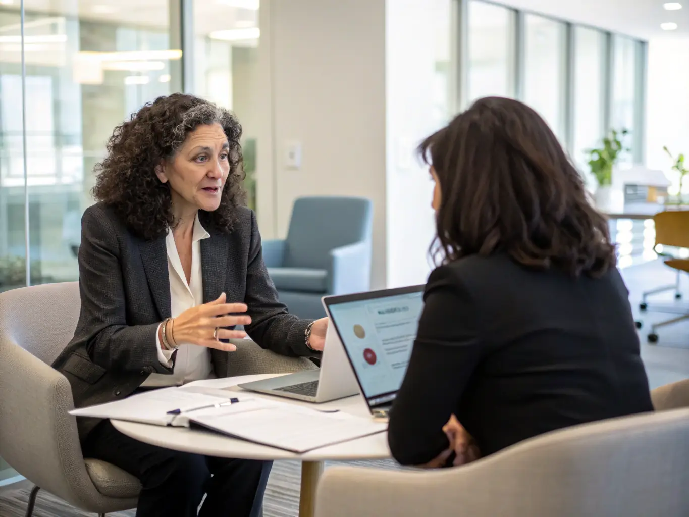A tax consultant discussing strategies with a client in an office setting, representing expert tax planning.